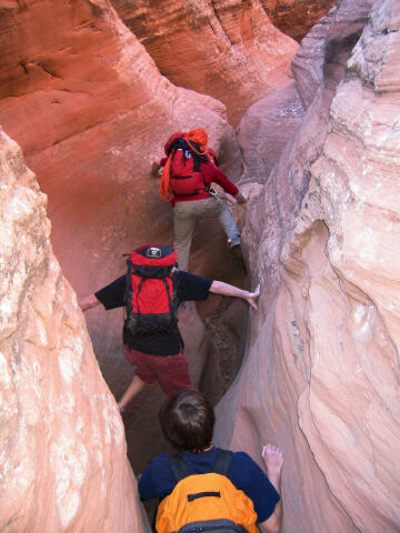 Mark, Kasey and Josh climbing through the slot.