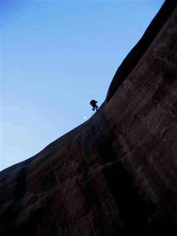 Mark Schnupp drops to the 4th tier with the moon peering over the cliff.